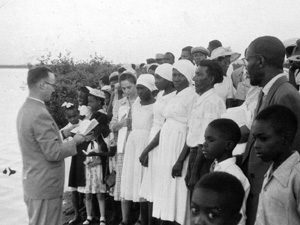 Mission worker Warren Metzler with a baptism class in Kingston Harbour, Jamaica, in 1957. VMC Archives